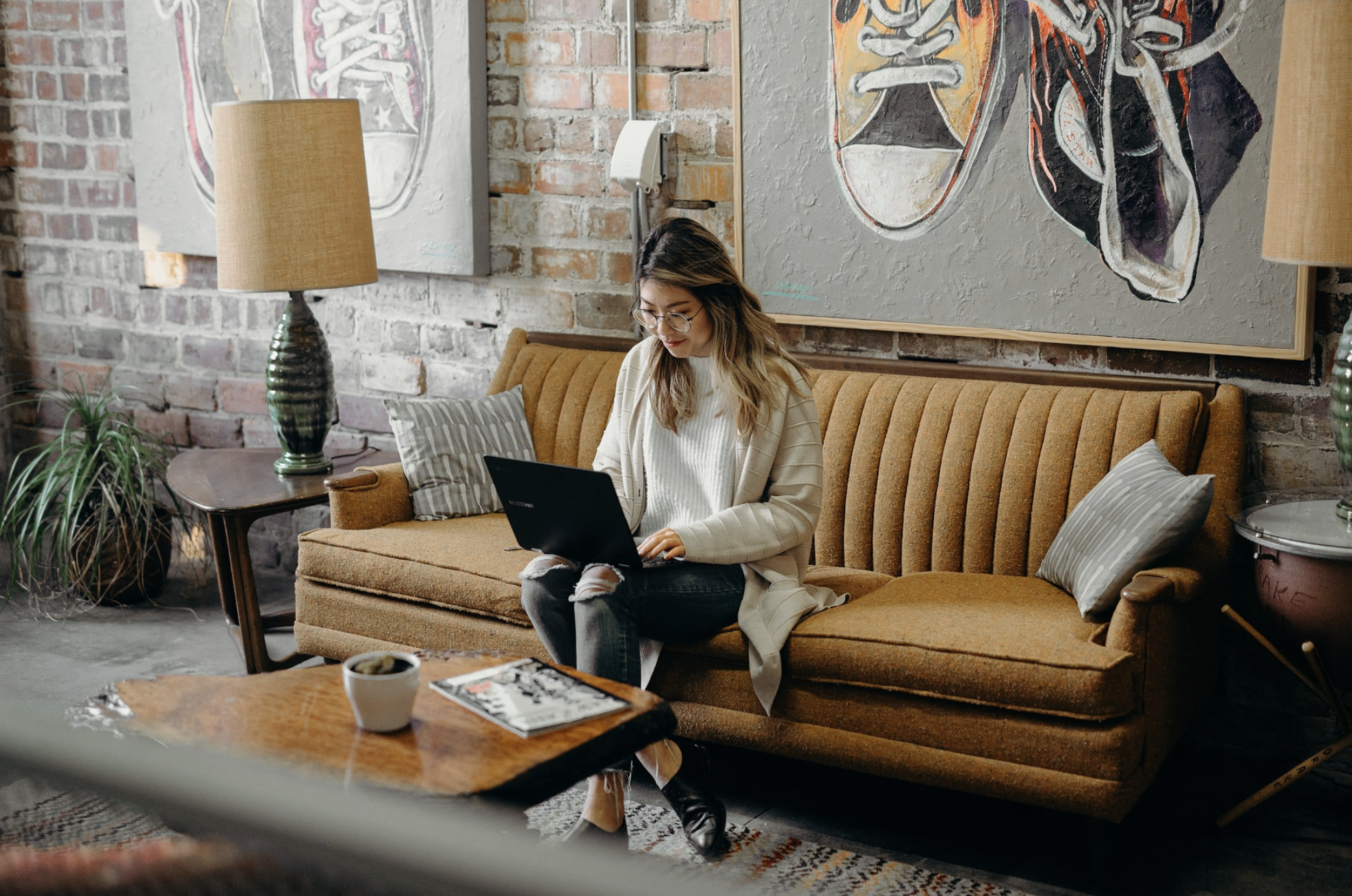 GTWC person centered therapy - woman sitting on bench with laptop