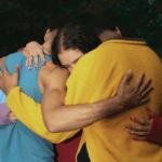 woman hugging two males - gtwc ask your therapist polyamory blog post