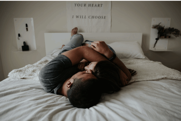 male and female couple laying in bed with "your heart I will choose" text poster in background - gtwc sex therapy article