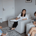 women laughing around couch-gtwc mediation