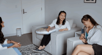 women laughing around couch-gtwc mediation
