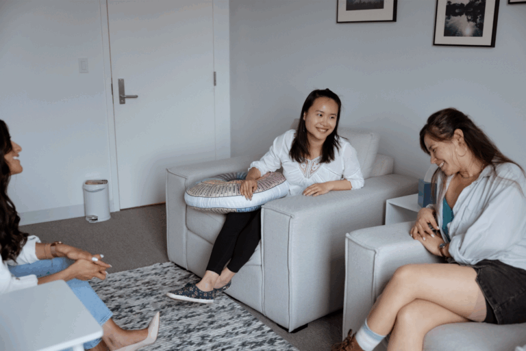 women laughing around couch-gtwc mediation