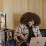 black woman smiling looking at computer - GTWC how to contact intake