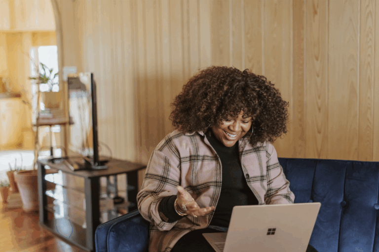 black woman smiling looking at computer - GTWC how to contact intake