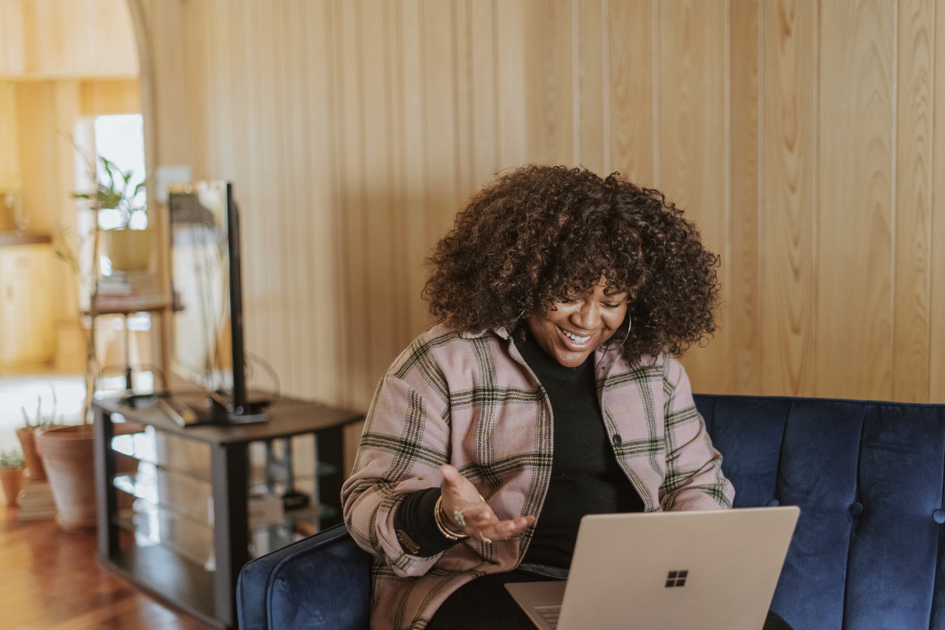 black woman smiling looking at computer - GTWC how to contact intake