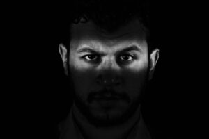 GTWC - How Masculinity and Anger Connect - man in shadows looking into camera