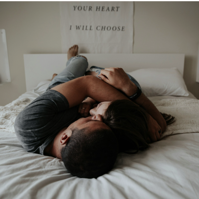 male and female couple laying in bed with "your heart I will choose" text poster in background - gtwc sex therapy article